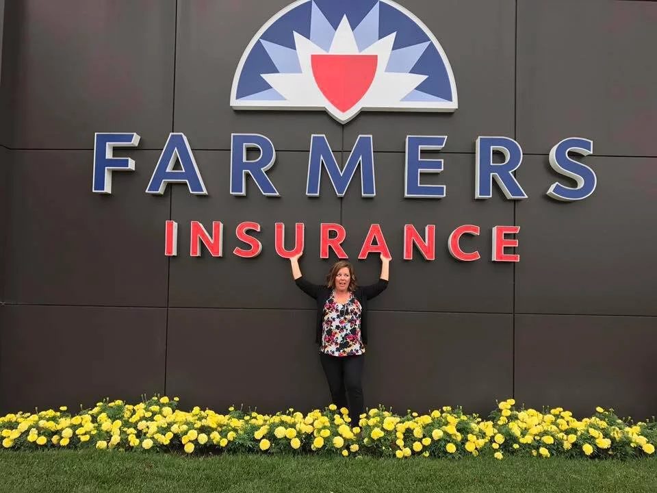 Tiffany Knupp standing in front of Farmers Insurance sign